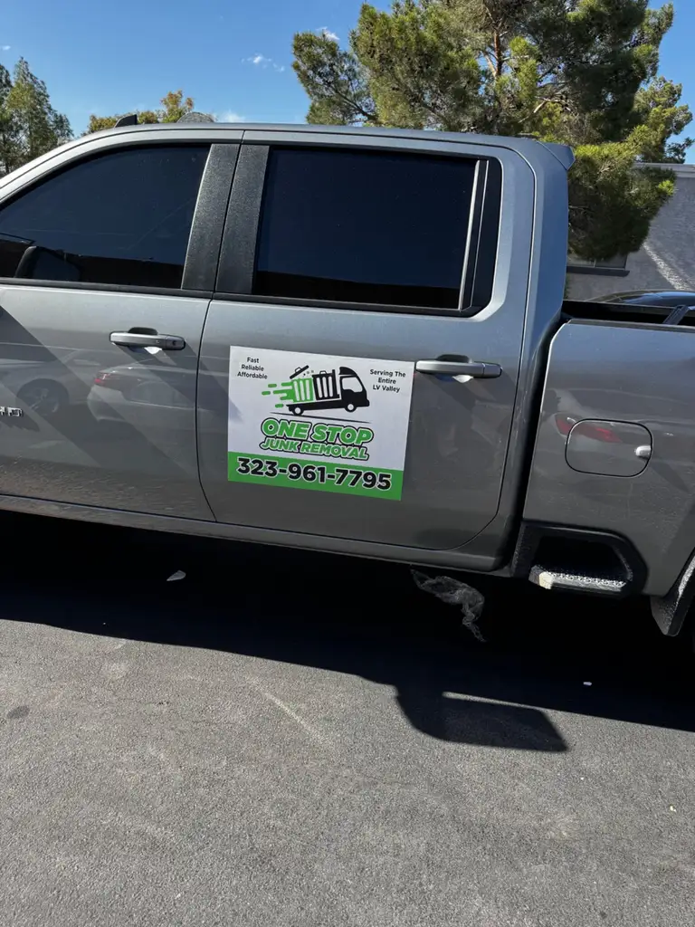The One Stop Junk Removal truck, door magnet and phone number visible